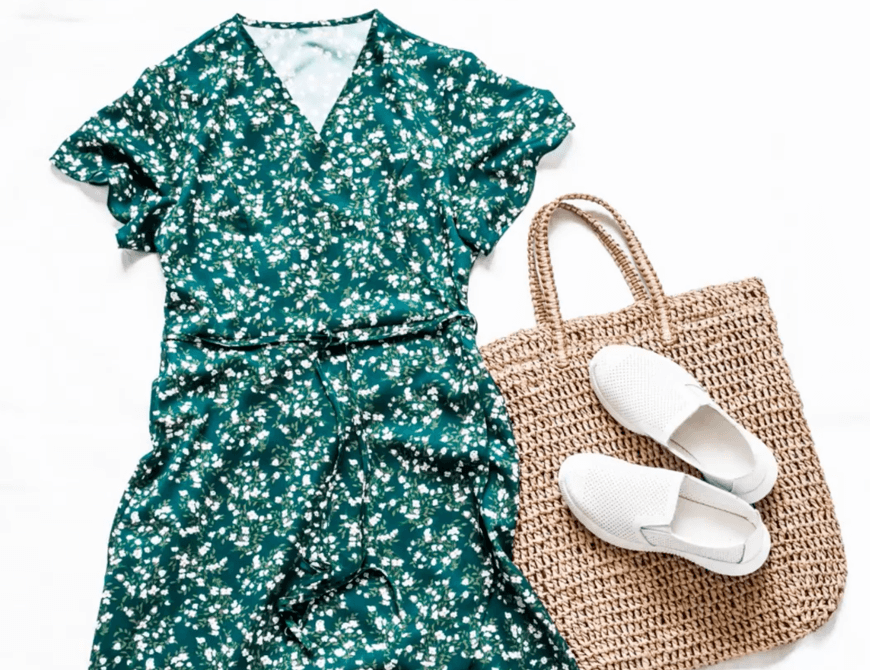 A green floral dress next to a brown crochet and white slip on shoes