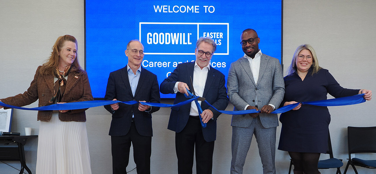 Leaders at Goodwill-Easter Seals Minnesota line up to cut a blue ribbon to open the new career and services campus